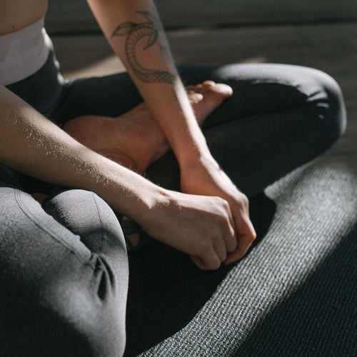 Close-up of a person's hands in a meditative pose.